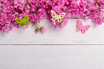 Pink flowers on wooden background