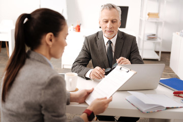 Positive delighted chef holding glasses in both hands