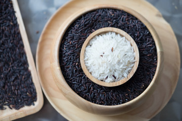 Jasmine rice in wooden bowl over Rice berry
