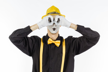 Man, Arist, pantomime holding a hand in front of his eyes and looks through binoculars . the...