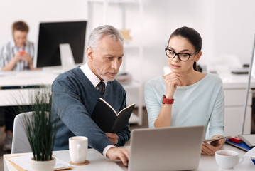 Very attentive man looking at computer