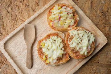 Homemade mini pizza buns different topped with mayonnaise sauce