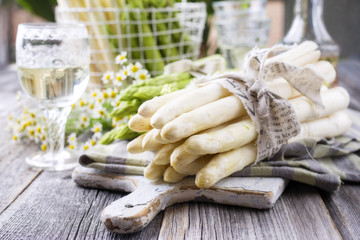 Row green and white Asparagus as close-up on a cutting board