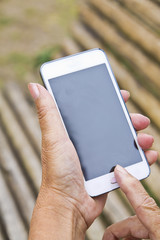 Hands of senior woman with cellphone
