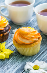 Still life with cup of tea and cake on the wooden background