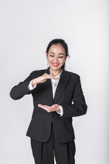 Attractive young beautiful Asian businesswoman showing empty copy space on her open hand palm