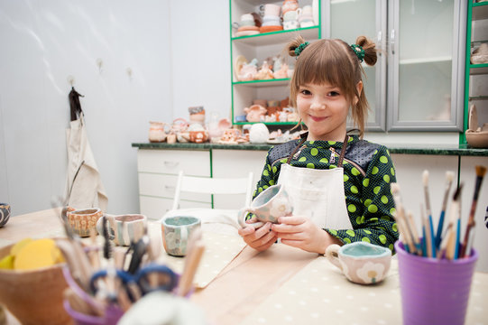 Little girl makes a ceramic product