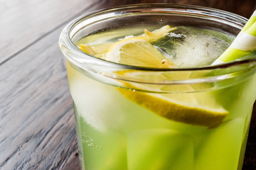 Midori Sour Cocktail with ice and lemon.
