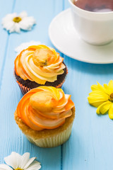 Still life with cup of tea and cake on the wooden background