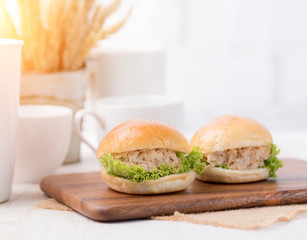 Mini Tuna Burgers on table wood against white brick wall