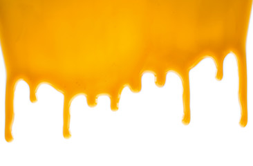 sweet caramel sauce dripping isolated on white background