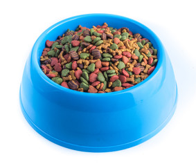 dry pet food in bowl on white background