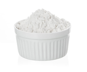 Bowl of white flour isolated on white background