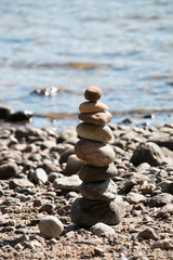 Fototapeta na wymiar Stack of stone arranged on the beach by the sea