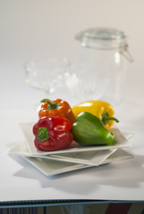 coloured bell peppers on white Background