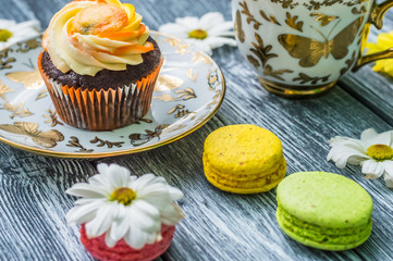 Still life with cup of tea and cake on the wooden background