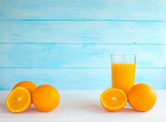 Fresh orange juice in a glass on a blue background