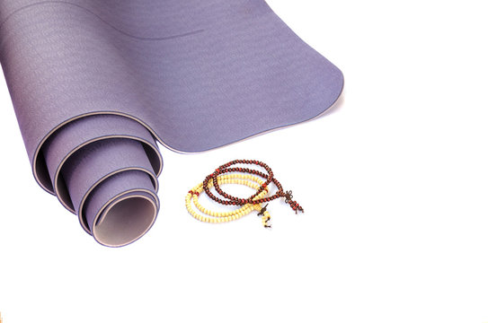 Yoga Accesories: Modern Lilac Mat With Two Mala Beads For Meditation  On White Isolated Background. Yoga Practice Concept.