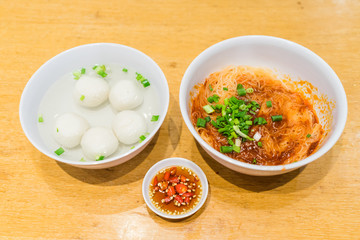 Teowchew Fishball noodles with soup and chili sauce on table