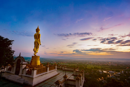 Wat Phra That Khao Noi, Nan Province, Thailand, Golden Buddha statue standing on a mountain,City of cultural and natural tourism in the north,selective focus