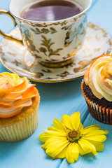 Still life with cup of tea and cake on the wooden background