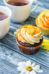 Still life with cup of tea and cake on the wooden background
