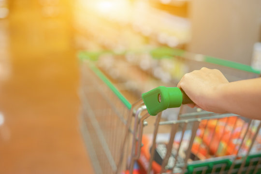 Abstract blurred photo of trolley in department store bokeh background,Shopping cart in supermarket ,vintage color