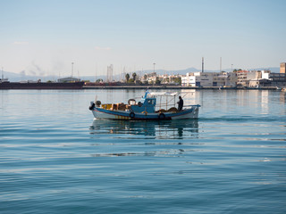 Fototapeta na wymiar Fishing boat leaving the port