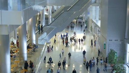 View from above, people walk in a large shopping center, make purchases.