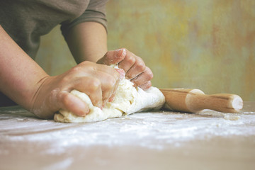 female hands rolling dough