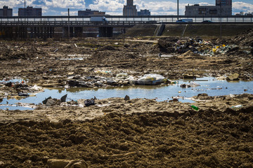 Garbage after construction in the city, bare land, swamp. The problem of ecology.