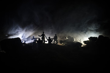 Fototapeta na wymiar War Concept. Military silhouettes fighting scene on war fog sky background, World War Soldiers Silhouettes Below Cloudy Skyline At night. Attack scene. Armored vehicles.