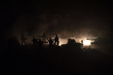 War Concept. Military silhouettes fighting scene on war fog sky background, World War Soldiers Silhouettes Below Cloudy Skyline At night. Attack scene. Armored vehicles.