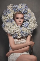 Attractive young woman face with flowers.