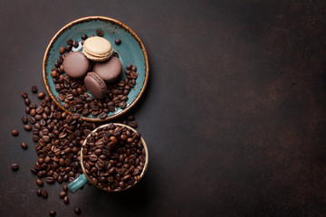 Coffee cup, beans, macaroons