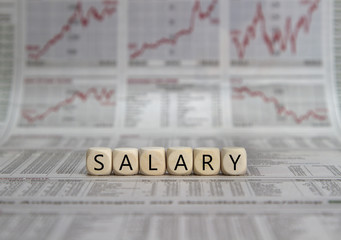 Salary word built with letter cubes