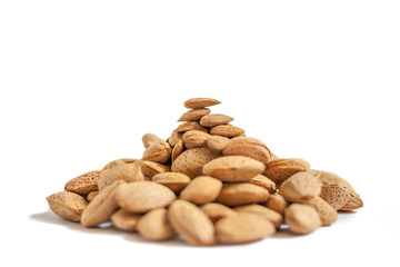 Fototapeta na wymiar A lot of almond nuts in the shell isolated on white background, selective focus