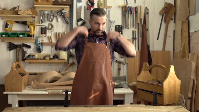 Cabinet Maker Begins his Working Day/Cabinet-maker comes to his joiner&rsquo;s shop, puts on his apron, takes a cabrioli table leg and begins working