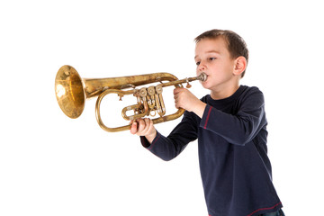 young boy blowing into a trumpet against white background © Miroslav Beneda