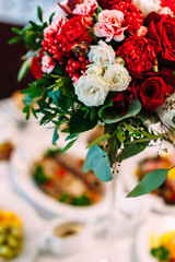 red bouquet table decoration in restaurant wedding