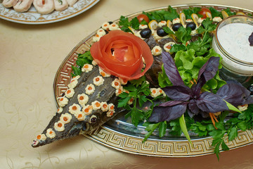Sturgeon with greenery on the plate.