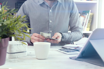 Fototapeta premium Man holds money. Conception of home budget.