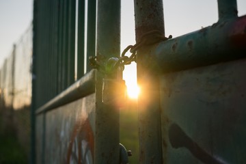 Padlock on the gate in the meadow fence. Slovakia