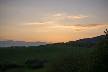 Sunset on meadow with hills and tree. Slovakia