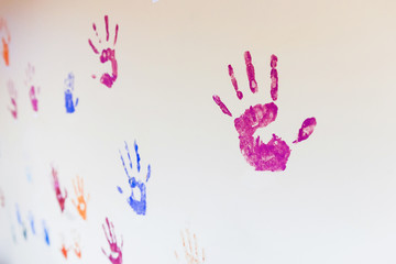 Fototapeta premium imprint of a child's hand on the wall. The concept of friendship and the background in a children's gym.