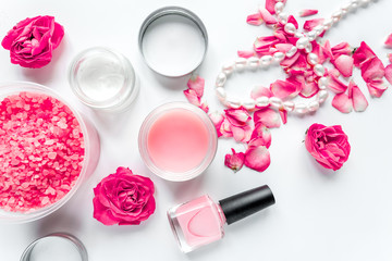 Obraz na płótnie Canvas Nail care spa set with rose polish, cream white background top view