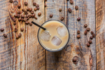 Ice coffee with milk for lunch on wooden background top view