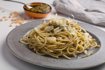 Spaghetti with pesto sauce and Parmesan cheese