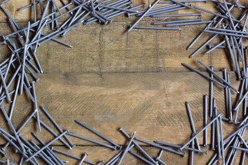 background of roofing nails scattered on the wooden deck