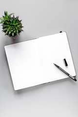 business plan with copybook on gray table background top view mock up